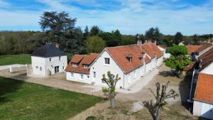 an aerial view of a large white house with red roofs at Le clos du cèdre in Cellettes
