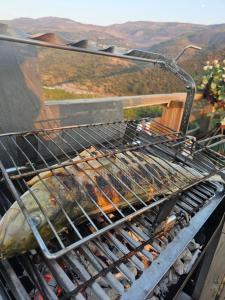 a grill with a bunch of food on it at La Tronera del Bierzo Restaurante-Hotel in Villadepalos