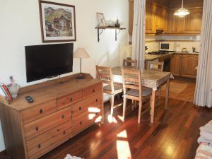 a kitchen and dining room with a table and a television at Watching Vilallonga de Ter in Vilallonga de Ter