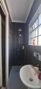 a blue bathroom with a sink and a shower at Godly Homes in Ruiru +45 photos
