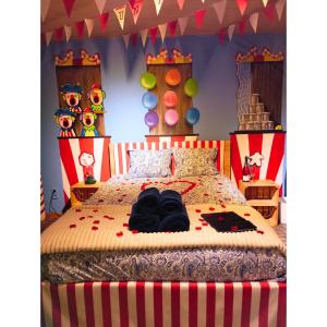 a bedroom with a bed with clothes on it at Emporium in Lobbes