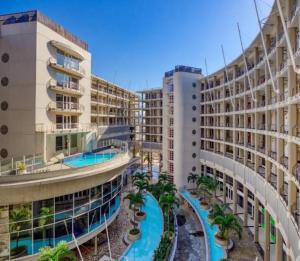 arial view of a building with two pools and palm trees at Two-Bedroom Durban Point Waterfront Penthouse in Durban