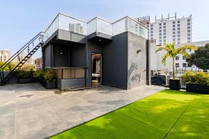 a house with a staircase on top of a yard at HomeGround Sector 89 -1RK in Gurgaon