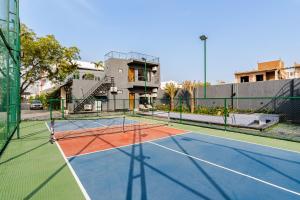 a tennis court in front of a building at HomeGround Sector 89 -1RK in Gurgaon