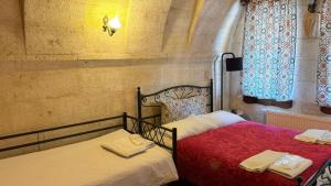 two beds sitting next to each other in a room at Nature Park Cave Hotel in Göreme +174 photos