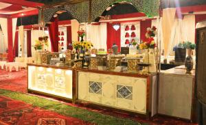 a restaurant with a counter with flowers on it at Kadamb Kuteer Hotel and Resort in Chhatikara