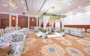 a banquet hall with chairs and a table in a room at Kadamb Kuteer Hotel and Resort in Chhatikara