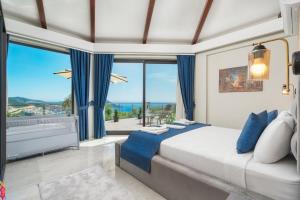 a bedroom with a large bed and a large window at Villa Ekinoks in Kalkan +28 photos