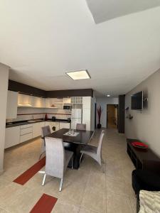 a living room with a table and chairs and a kitchen at Nova IVE Apart in San Luis