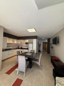 a kitchen and living room with a table and chairs at Nova IVE Apart in San Luis