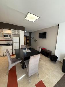 a kitchen and dining room with a black table and chairs at Nova IVE Apart in San Luis +6 photos