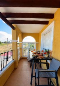a dining room with a table and chairs on a balcony at Casa suerte in Algorfa