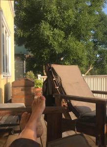 a person with their feet up on a bench at Lakeside House, Storstugan in Ramvik