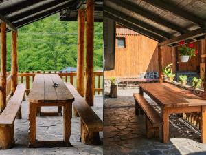 a wooden table and bench on a patio at Cabana Tarța din Blidari 1 in Baia Mare