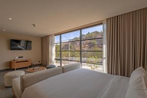 a hotel room with a bed and a large window at Riva Hua Hin in Ban Khao Takiap +70 photos