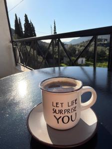 a cup of coffee sitting on top of a table at Zarakas home in Monemvasia