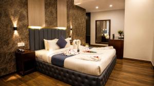 a bedroom with a large bed with towels on it at Hotel Crown Park Ltd in Sylhet +61 photos
