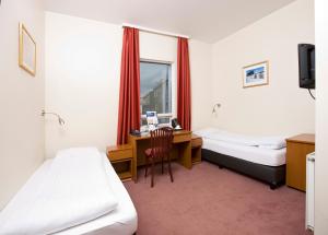 Postel nebo postele na pokoji v ubytování Fosshotel Baron