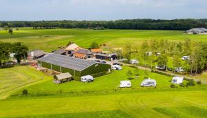 an aerial view of a farm with cars parked in a field at Glampingtent 't Haller Vorden in Vorden