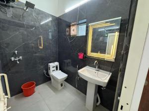 a bathroom with a sink and a toilet at Mangalm Farm & Resort in Greater Noida +17 photos