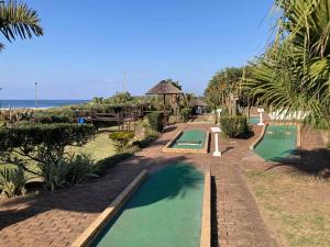 a resort with two swimming pools next to the ocean at Anchors Aweigh in Hibberdene