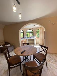 a living room with a table and chairs and a kitchen at Готель Соняшник in Solotvyno