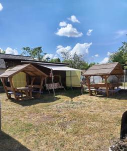a tent and a gazebo in a yard at Luca Apartman in Esztergom