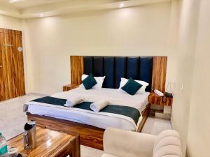 a bedroom with a large bed with a black headboard at Shree Krishna Palace Hotel - Couple Friendly in Lucknow
