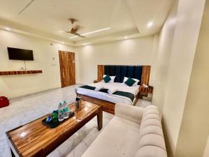 a living room with a bed and a couch at Shree Krishna Palace Hotel - Couple Friendly in Lucknow