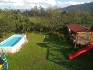 a backyard with a swimming pool and a house at Villa NEA Ilidza in Sarajevo