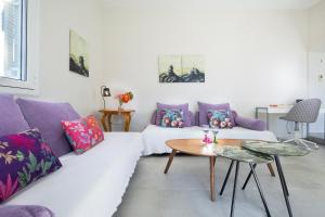 a living room with a white couch and purple pillows at Villa Memories in Palaiochora