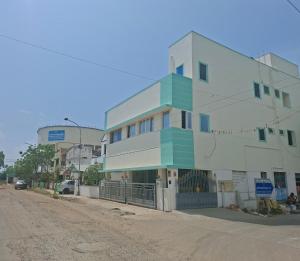 a building on the side of a dirt road at Kattil Chennai in Chennai