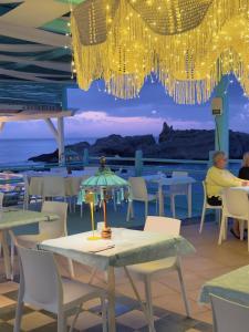 a restaurant with a table with a view of the ocean at Oldwell Hotel in Santa Domenica
