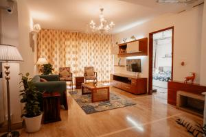 a living room with a couch and a table at LUHO Grande in Bangalore