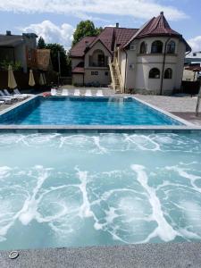 a swimming pool in front of a house at Готель Соняшник in Solotvyno +34 photos