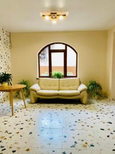 a living room with a couch and a window at Готель Соняшник in Solotvyno