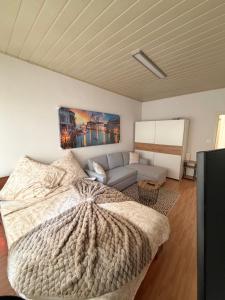 a bedroom with a large bed and a couch at Amor Mosel Stay in Klotten