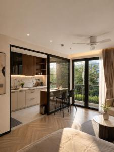 a kitchen and living room with a table and chairs at AMA Residences in Buon Ma Thuot
