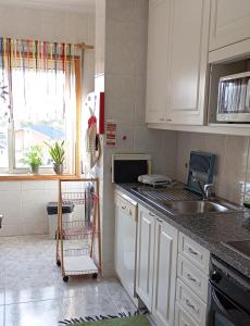 a kitchen with a sink and a counter top at Aguda Mar - V N Gaia in Aguda