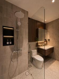 a bathroom with a shower and a toilet and a sink at AMA Residences in Buon Ma Thuot +24 photos