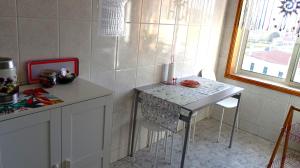 a kitchen with a small table and a table and chairs at Aguda Mar - V N Gaia in Aguda +19 photos