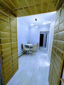 a dining room with a table and chairs at Taraz in Taraz +5 photos
