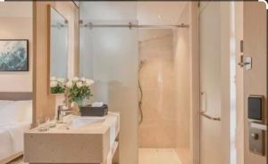 a bathroom with a shower and a sink and a shower at Arena Resort Cam Ranh in Cam Ranh International Airport +1 photo