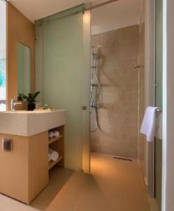 a bathroom with a shower and a sink at Arena Resort Cam Ranh in Cam Ranh International Airport