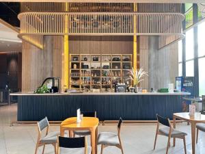 a restaurant with tables and chairs and a bar at Arena Resort Cam Ranh in Cam Ranh International Airport