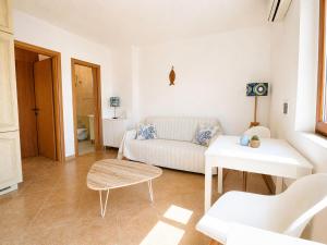 a living room with a white couch and a table at Maridea - Vairone in Ponza