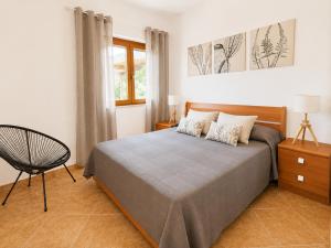 a bedroom with a bed and a chair in it at Maridea - Vairone in Ponza