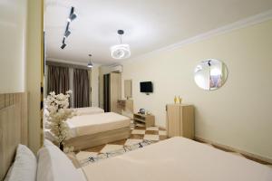 a hotel room with two beds and a mirror at Pyramids Stars Egypt in Cairo