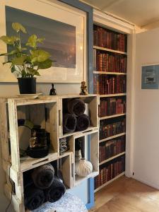 a book shelf filled with lots of books at Le Bach - Rustic Central Raglan in Raglan