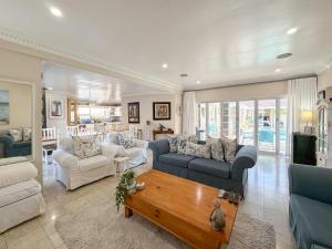 a living room with couches and a coffee table at Atlantic Beach Villa in Cape Town